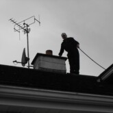 Chimney Sweep On The Roof