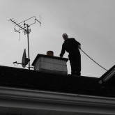 Chimney Sweep On The Roof